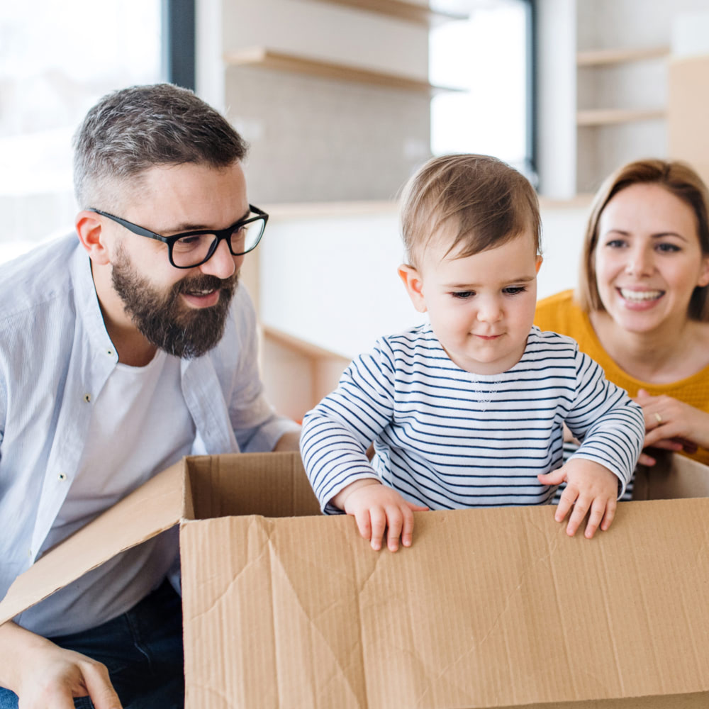 Couple with their child playing in a box